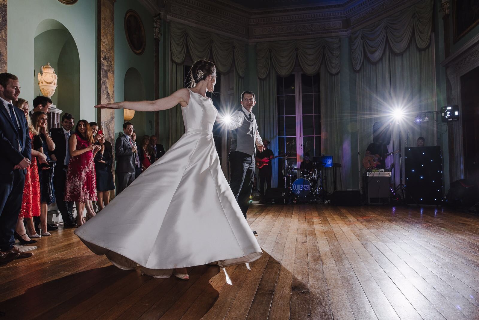 A bride and groom performing a graceful spin during their first dance after taking private dance classes London