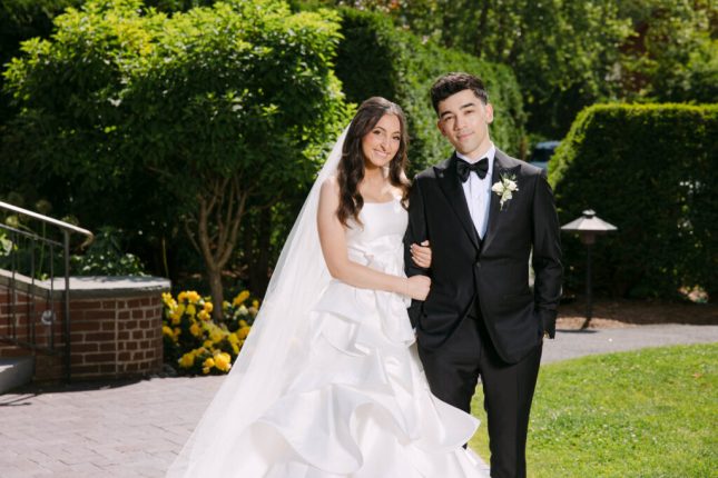 Vermont wedding photographer capturing a bride and groom smiling together in a garden setting on their wedding day.